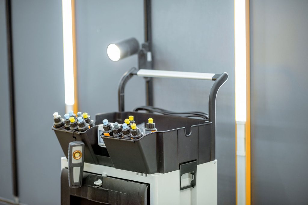 auto detailer cart featuring an led inspection light and various wax or polish bottles